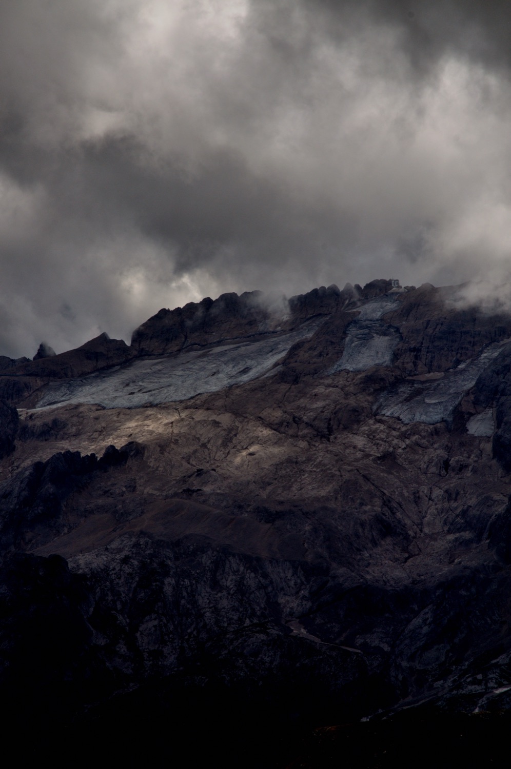 Dark clouds over a glacier on a mountain ridge